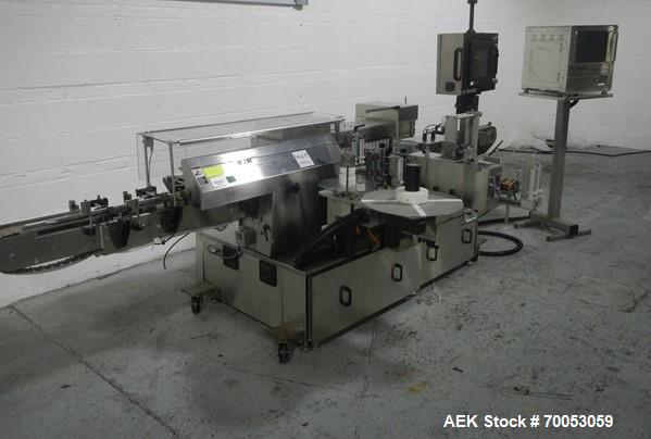 Used Used New Jersey wrap around labeler, model 334RSTP, speeds up to 400 units/minute, trunion roll bottle handling system, Open Date coder, model Printmaster R/H, size range of 1" -14" container he...