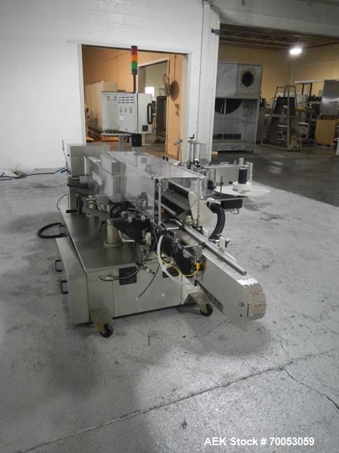 Used-Used New Jersey wrap around labeler, model 334RSTP, speeds up to 400 units/minute, trunion roll bottle handling system,...