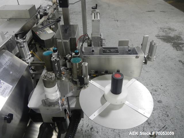 Used Used New Jersey wrap around labeler, model 334RSTP, speeds up to 400 units/minute, trunion roll bottle handling system, Open Date coder, model Printmaster R/H, size range of 1" -14" container he...