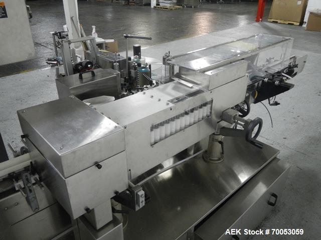 Used-Used New Jersey wrap around labeler, model 334RSTP, speeds up to 400 units/minute, trunion roll bottle handling system,...