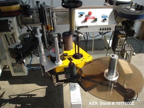 Used CCL Collomat Wrap Around Pressure Sensitive Labeler, model 6600. Can handle a label up to 6.75" high, currently set to run 3.25" high labels. 136.5" long x 4.5" wide conveyor, table top chain be...
