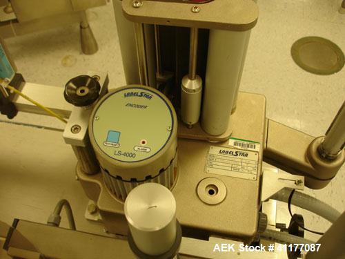 Used Kalish Labelstar Wraparound Pressure Sensitve Labeler, Model LS4000. Capable of speeds up to 150 cpm. Unit has Acuity PMC80 vision system, open date hot stamp coder bump wheel indexing, top hold...