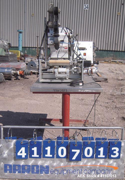 Used Labeling Systems Inc (LSI) Semi Automatic Wrap Around Labeler, Model 301S. Designed for semi automatic wrap around labeling of products such as bottles, vials or cans. Maximum bottle size 12" hi...