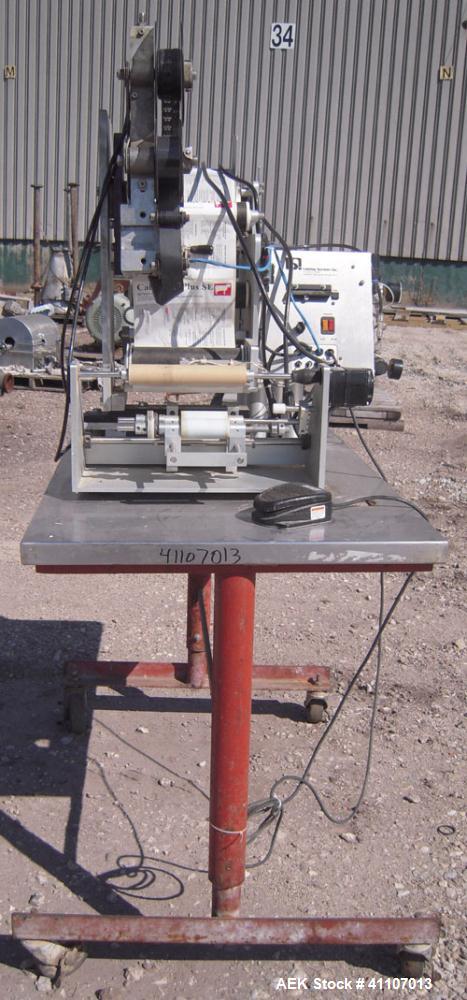 Used Labeling Systems Inc (LSI) Semi Automatic Wrap Around Labeler, Model 301S. Designed for semi automatic wrap around labeling of products such as bottles, vials or cans. Maximum bottle size 12" hi...