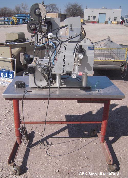 Used Labeling Systems Inc (LSI) Semi Automatic Wrap Around Labeler, Model 301S. Designed for semi automatic wrap around labeling of products such as bottles, vials or cans. Maximum bottle size 12" hi...