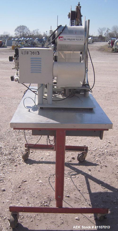 Used Labeling Systems Inc (LSI) Semi Automatic Wrap Around Labeler, Model 301S. Designed for semi automatic wrap around labeling of products such as bottles, vials or cans. Maximum bottle size 12" hi...