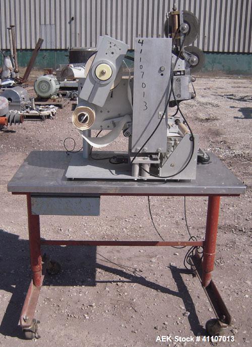 Used Labeling Systems Inc (LSI) Semi Automatic Wrap Around Labeler, Model 301S. Designed for semi automatic wrap around labeling of products such as bottles, vials or cans. Maximum bottle size 12" hi...
