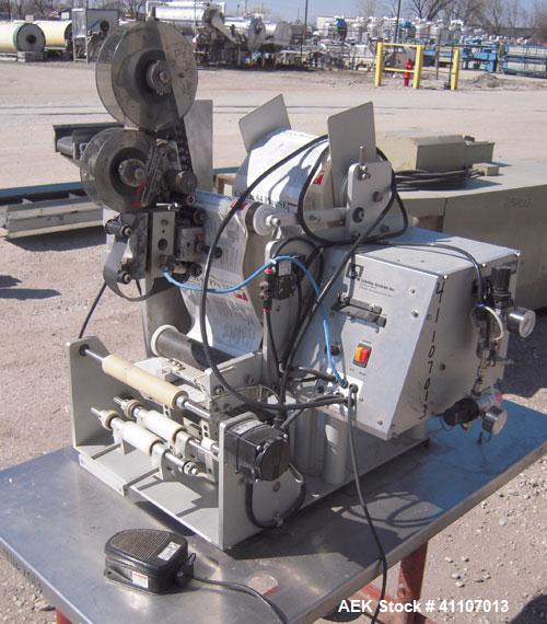 Used Labeling Systems Inc (LSI) Semi Automatic Wrap Around Labeler, Model 301S. Designed for semi automatic wrap around labeling of products such as bottles, vials or cans. Maximum bottle size 12" hi...