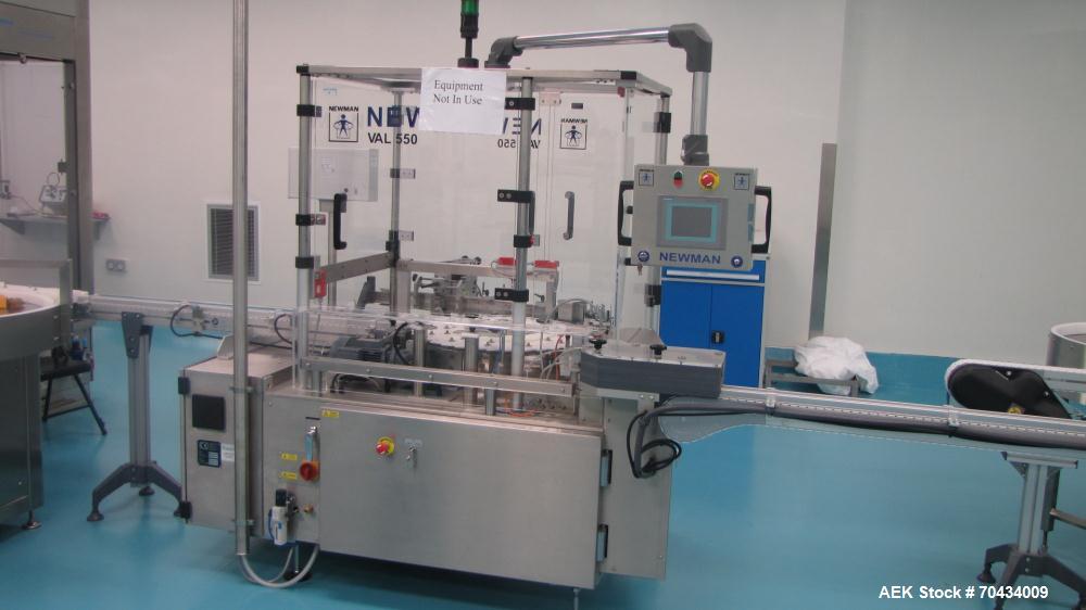 Used Newman Model VAL550 Labeller. Approximate maximum output 600 cpm. Includes PCE control system and in / out conveyors. Container size range: (Diameter) 8mm - 50mm. Label size range: (Height) 12mm...