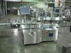 Used One (1) used Aesus wrap around labeler, model Premier Panel 362P, Herma label head, vision system, side bump belts, top hold down belt, reject and controls, 1/60/208 volt,