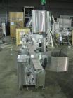 Used One (1) used Aesus wrap around labeler, model Premier Panel 362P, Herma label head, vision system, side bump belts, top hold down belt, reject and controls, 1/60/208 volt,