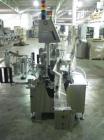 Used One (1) used Aesus wrap around labeler, model Premier Panel 362P, Herma label head, vision system, side bump belts, top hold down belt, reject and controls, 1/60/208 volt,