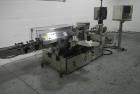 Used Used New Jersey wrap around labeler, model 334RSTP, speeds up to 400 units/minute, trunion roll bottle handling system, Open Date coder, model Printmaster R/H, size range of 1