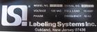 Used Labeling Systems Inc (LSI) Semi Automatic Wrap Around Labeler, Model 301S. Designed for semi automatic wrap around labeling of products such as bottles, vials or cans. Maximum bottle size 12
