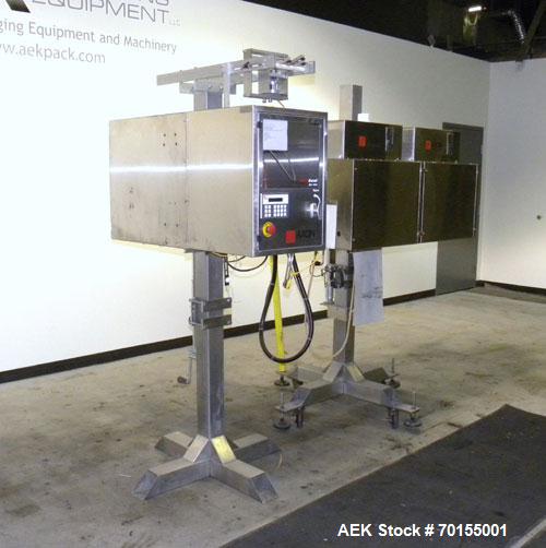 Used Axon Corporation EZ-100 Tamper Evident Band and Sleeve Label Applicator capable of speeds up to 150 packages per minute. Stainless steel design. Has vertical perforation, power unwind station an...