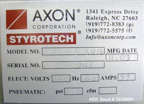 Used Axon Corporation EZ-100 Tamper Evident Band and Sleeve Label Applicator capable of speeds up to 150 packages per minute. Stainless steel design. Has vertical perforation, power unwind station an...