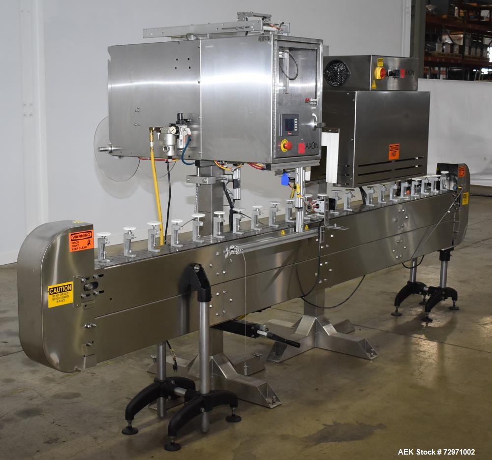 Used Axon Styrotech EZ-Seal EZ-200 Single Head Tamper Evident Neck Bander. Designed to run up to 120 containers per minute. 1-60/115 volt, 10 amp, serial # T-100210B, built 05/2010. Includes a heat s...