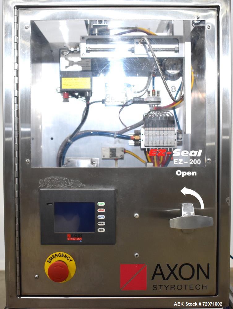 Used Axon Styrotech EZ-Seal EZ-200 Single Head Tamper Evident Neck Bander. Designed to run up to 120 containers per minute. 1-60/115 volt, 10 amp, serial # T-100210B, built 05/2010. Includes a heat s...