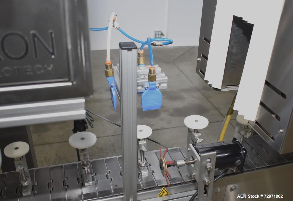Used Axon Styrotech EZ-Seal EZ-200 Single Head Tamper Evident Neck Bander. Designed to run up to 120 containers per minute. 1-60/115 volt, 10 amp, serial # T-100210B, built 05/2010. Includes a heat s...