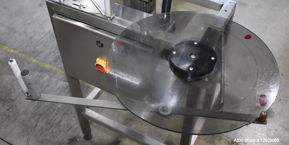 Used Marburg Industries Model M-725-FB Auto Cap Sealer. Approximate speeds up to 200 units per minute. Approximate bands up to a 70mm closure. Has Mitsubishi MELSEC PLC, Mitsubishi drive. Serial# 165...