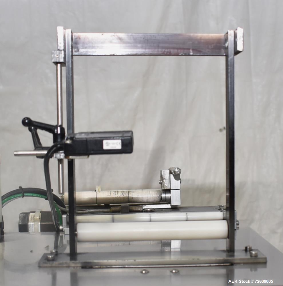 Used Marburg Industries Model M-725-FB Auto Cap Sealer. Approximate speeds up to 200 units per minute. Approximate bands up to a 70mm closure. Has Mitsubishi MELSEC PLC, Mitsubishi drive. Serial# 165...