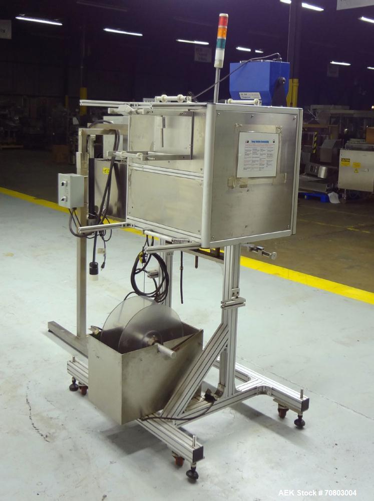 Used TriPack LSA-160 Automatic Shrink Sleeve Labeler Applicator / Neck Bander. Capable of speeds up to 100 BPM. Layflat width 40mm-170mm. Product Diameter 1" to 4.25". Cut off length 30mm-200mm. Thic...