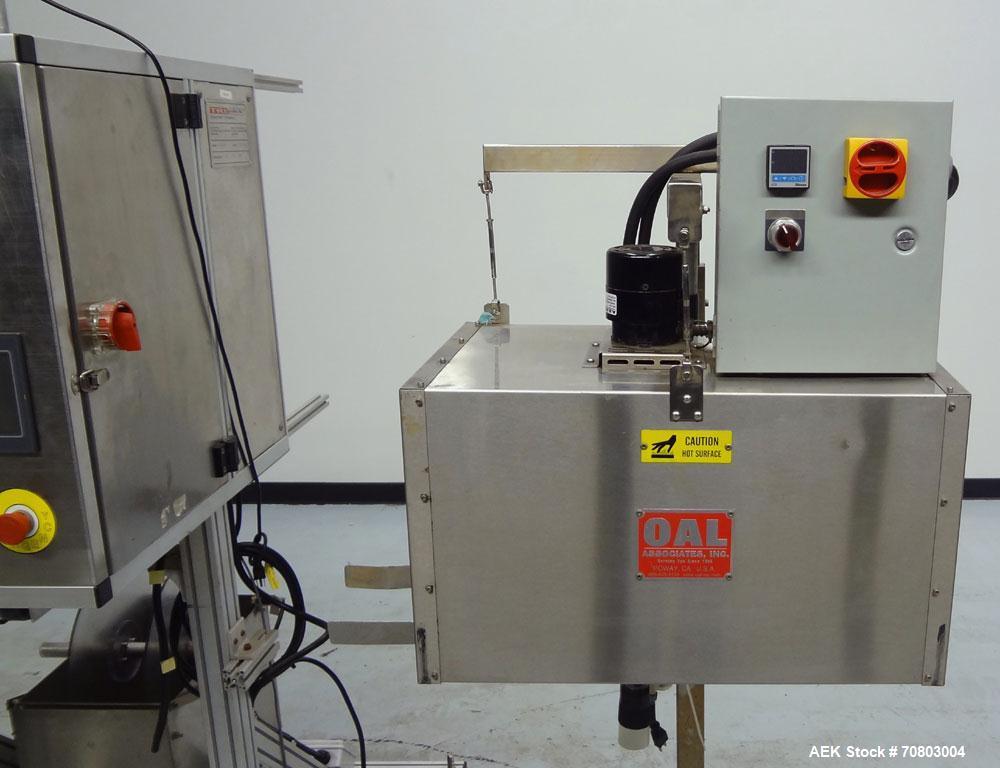 Used TriPack LSA-160 Automatic Shrink Sleeve Labeler Applicator / Neck Bander. Capable of speeds up to 100 BPM. Layflat width 40mm-170mm. Product Diameter 1" to 4.25". Cut off length 30mm-200mm. Thic...