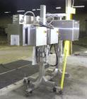 Used Axon Corporation EZ-100 Tamper Evident Band and Sleeve Label Applicator capable of speeds up to 150 packages per minute. Stainless steel design. Has vertical perforation, power unwind station an...