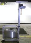 Used Axon Corporation EZ-100 Tamper Evident Band and Sleeve Label Applicator capable of speeds up to 150 packages per minute. Stainless steel design. Has vertical perforation, power unwind station an...