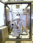 Used Axon Corporation EZ-100 Tamper Evident Band and Sleeve Label Applicator capable of speeds up to 150 packages per minute. Stainless steel design. Has vertical perforation, power unwind station an...