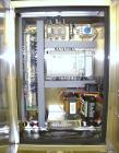 Used Axon Corporation EZ-100 Tamper Evident Band and Sleeve Label Applicator capable of speeds up to 150 packages per minute. Stainless steel design. Has vertical perforation, power unwind station an...