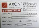 Used Axon Corporation EZ-100 Tamper Evident Band and Sleeve Label Applicator capable of speeds up to 150 packages per minute. Stainless steel design. Has vertical perforation, power unwind station an...