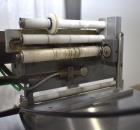 Used Marburg Industries Model M-725-FB Auto Cap Sealer. Approximate speeds up to 200 units per minute. Approximate bands up to a 70mm closure. Has Mitsubishi MELSEC PLC, Mitsubishi drive. Serial# 165...