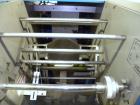 Used SleeveCo Model ST-2200R Stretch Sleeve Applicator capable of speeds up to 60 bottles per minute. Currently set up on round gallon containers, has film registration. Machine footprint 48