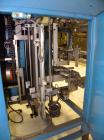 Used SleeveCo Model ST-2200R Stretch Sleeve Applicator capable of speeds up to 60 bottles per minute. Currently set up on round gallon containers, has film registration. Machine footprint 48
