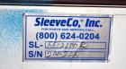 Used SleeveCo Model ST-2200R Stretch Sleeve Applicator capable of speeds up to 60 bottles per minute. Currently set up on round gallon containers, has film registration. Machine footprint 48
