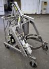 Used Drum Runner Material Handling Drum Lift-Carry-Rotate-Pour, Model 4600A-H, carbon steel, 800 pound drum capacity.  Air lift and tilt with holding tank.  Designed for plastic, steel, and fiber dru...