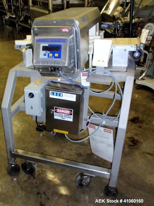 Used Lock Inspection Systems Metal Detector, Model MET 30+, belt thru design, 14" wide x 5" high opening, 7.5" wide x 30" long belt, 115 volt with controls on stand.