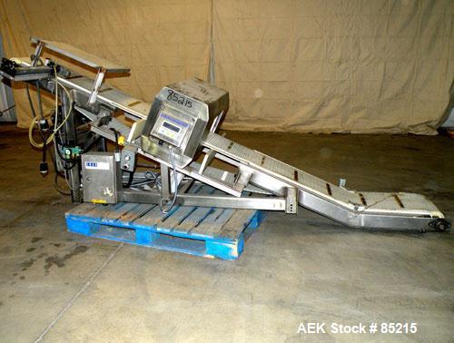 Used Lock Metalchek Metal Detector, Model 30CKE. Aperture size 14" wide x 7" high. Includes a 12" wide x 2' long bottom section x 8'6" long incline section x 46" discharge height plastic belt conveyo...