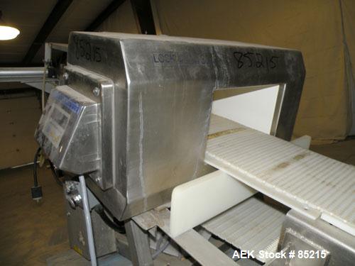 Used Lock Metalchek Metal Detector, Model 30CKE. Aperture size 14" wide x 7" high. Includes a 12" wide x 2' long bottom section x 8'6" long incline section x 46" discharge height plastic belt conveyo...