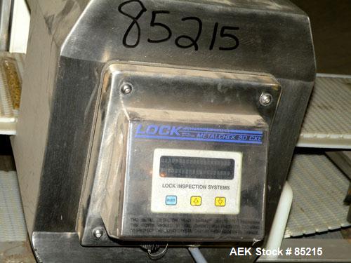 Used Lock Metalchek Metal Detector, Model 30CKE. Aperture size 14" wide x 7" high. Includes a 12" wide x 2' long bottom section x 8'6" long incline section x 46" discharge height plastic belt conveyo...
