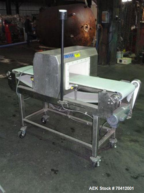 Used Lock Model Met 30+ Universal 3F Metal Detector. Machine has conveyor attached. Has a 13" wide x 6.5" high aperture. All stainless steel head mounted on a 12" wide x 60" long conveyor with caster...