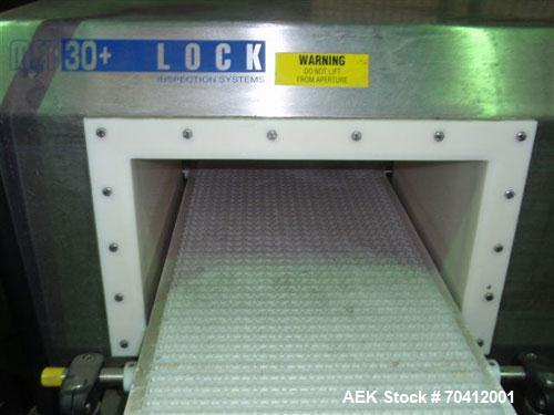 Used Lock Model Met 30+ Universal 3F Metal Detector. Machine has conveyor attached. Has a 13" wide x 6.5" high aperture. All stainless steel head mounted on a 12" wide x 60" long conveyor with caster...
