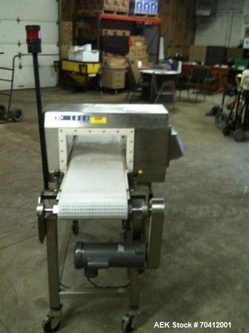 Used Lock Model Met 30+ Universal 3F Metal Detector. Machine has conveyor attached. Has a 13" wide x 6.5" high aperture. All stainless steel head mounted on a 12" wide x 60" long conveyor with caster...