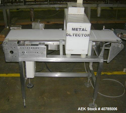 Used Lock Inspection Systems Metal Check 9 Metal Detector. 10" wide x 48" long belt.14" wide x 4 1/2" tall aperture opening. Driven by a 1/4 hp, 104 rpm DC motor with varispeed speed control, ratio 3...