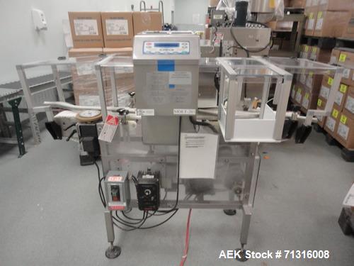 Used Loma Model IQ2 Metal Detector with conveyor and reject. Metal detector is vertical and last set up for solid dose bottling line. Head is 5"W x 10"H as 12"Deep. Includes integral chain conveyor w...
