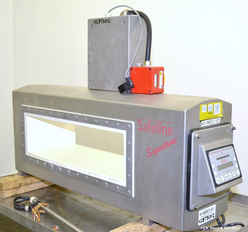 Used Safeline Signature 2 Pass Through Metal Detector, 304 Stainless Steel. Aperture size approximately 25-1/2" wide x 7" high x 11" long. Sensitivity Ratio dependent of coil system at 300 kHz, Non-F...