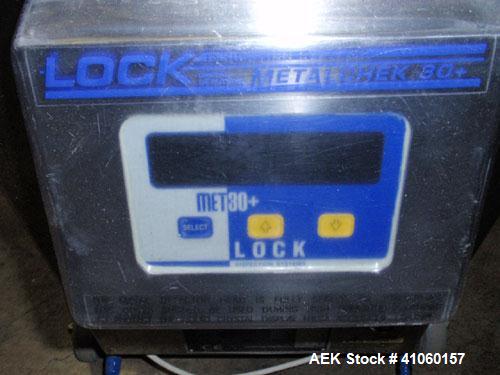Used Lock Inspection Systems Fall Thru Metal Detector, Model MET 30+ Universal. 3 3/4" wide x 1-3/4" high opening with reject, 115 volt with controls on stand. Capable of 30,000 tablets/capsules per ...