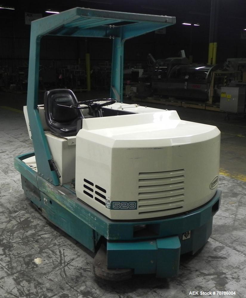 Used Tennant Model 528 SRS Edition Riding Floor Scrubber. Has a 4-cycle propane powered engine. Has 122 gallon solution tank and 4.9 gallon cleaning solution tank. Has (1) 11" and (1) 13" scrub brush...