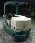Used- Tennant Model 528 SRS Edition Riding Floor Scrubber. Has a 4-cycle propane powered engine. Has 122 gallon solution tan...